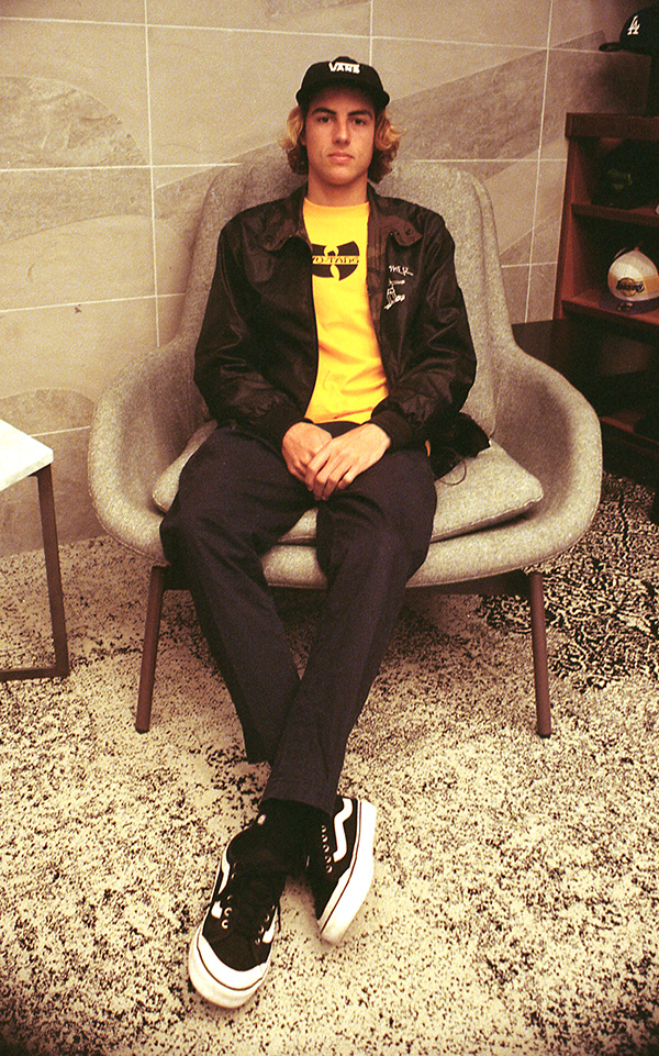 35mm film portrait of a skateboarder seated in a lounge chair